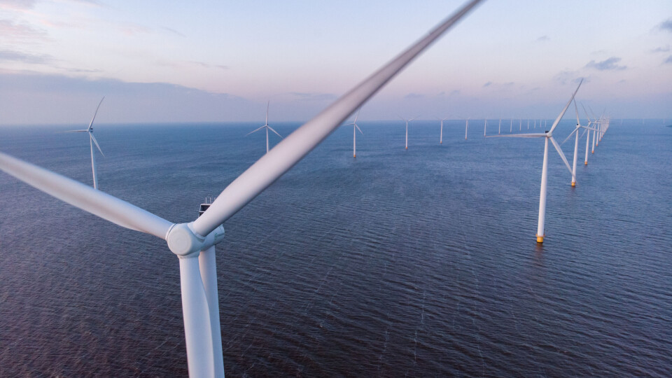 A close up photo of a wind farm turbine offshore