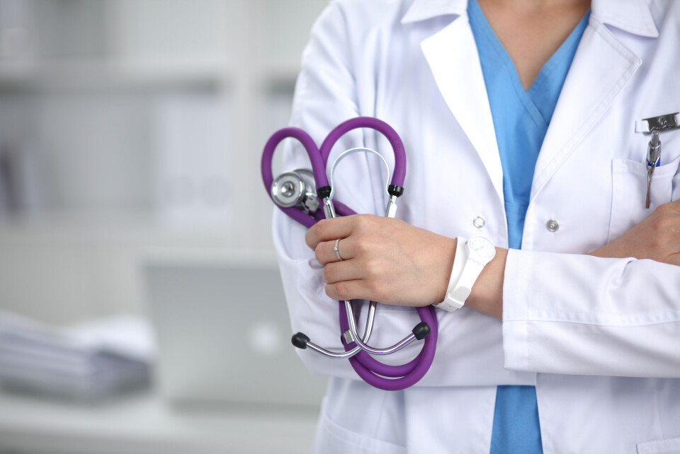 An anonymous female doctor holding a stethoscope