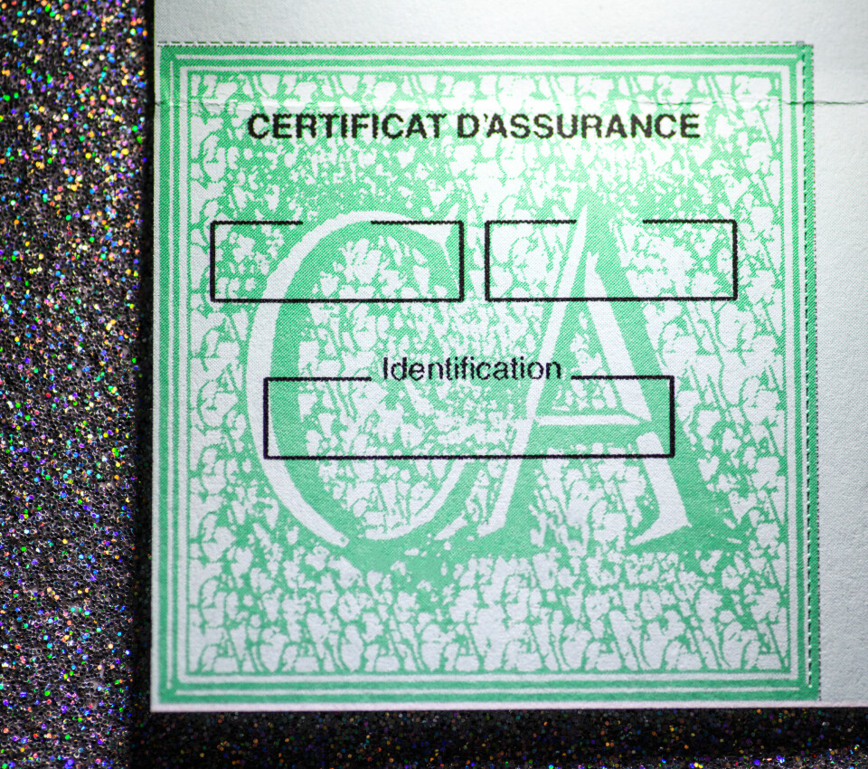 Close up of green certificat d’assurance car insurance sticker