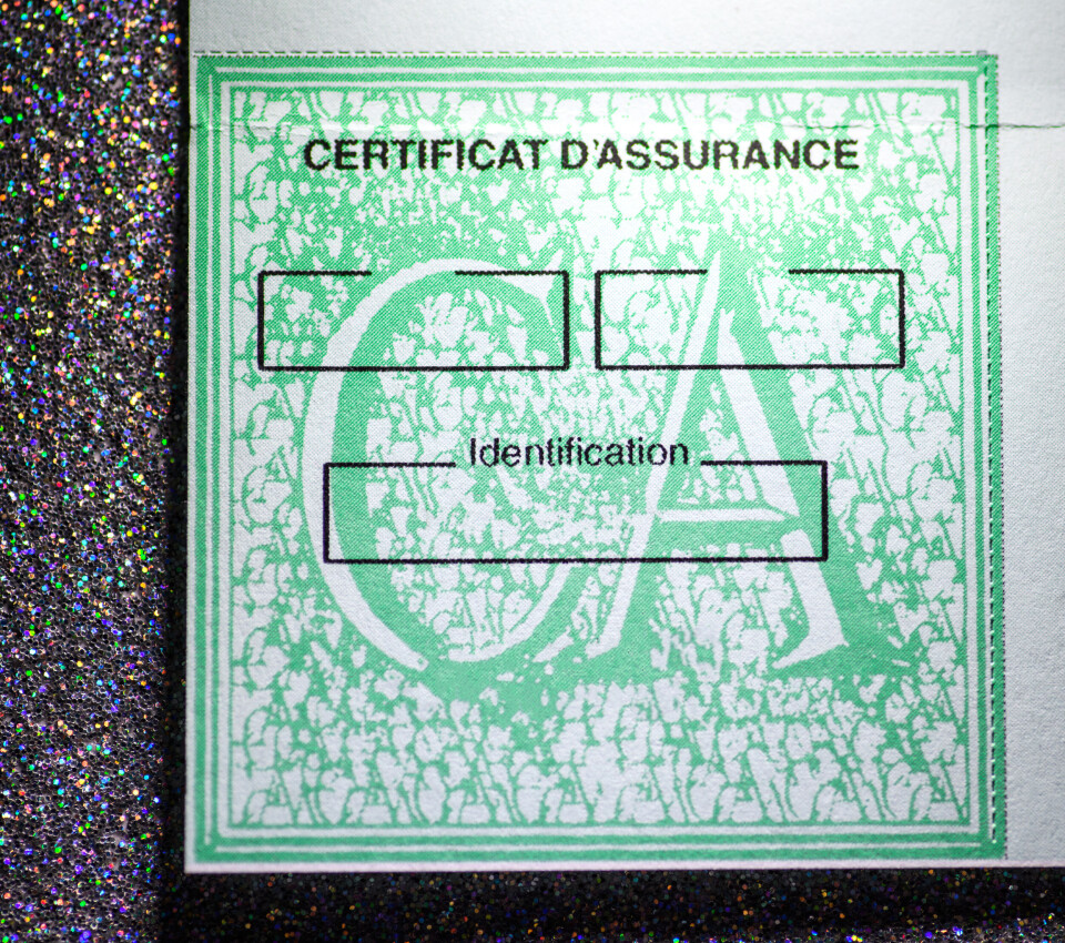 Close up of green certificat d’assurance car insurance sticker