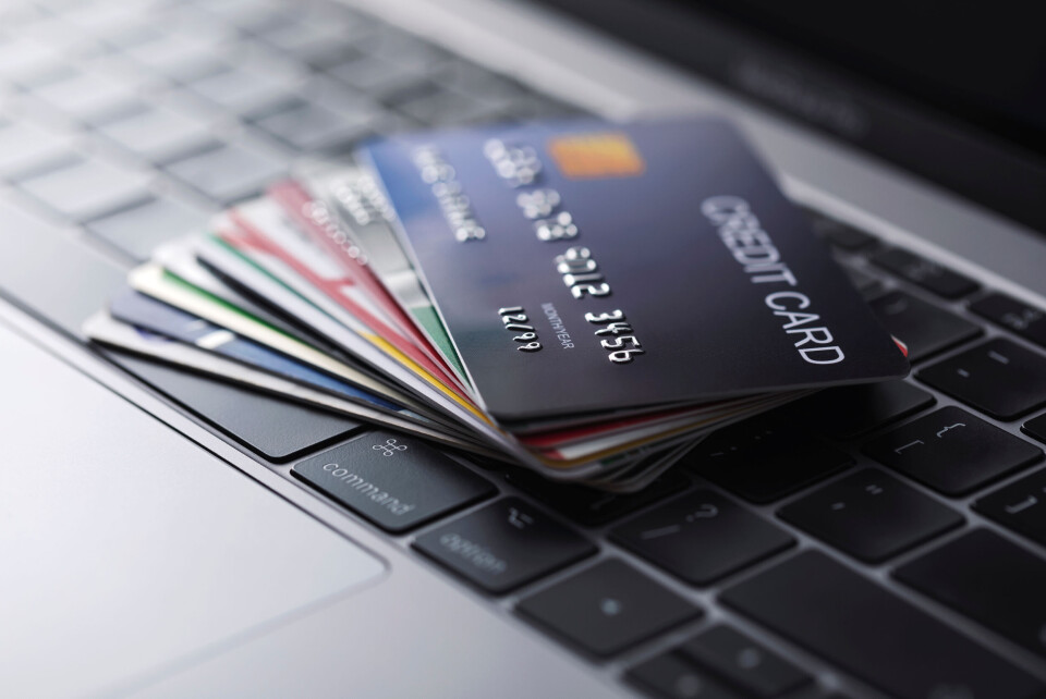 Suradech Prapairat / Shutterstock Bank cards lying on a laptop