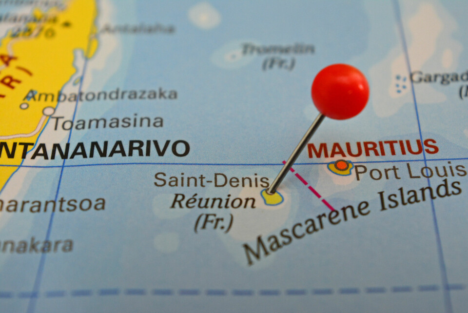 A close up of a pin in La Réunion island on a map