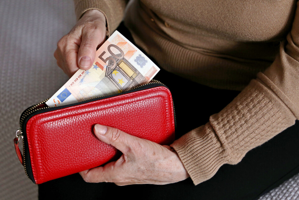 Oleg Elkov / Shutterstock Older lady with 50 euro note