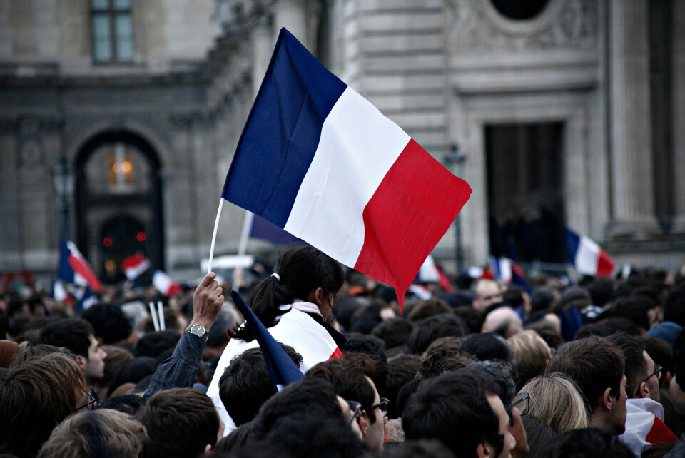 Crowd holding French flag