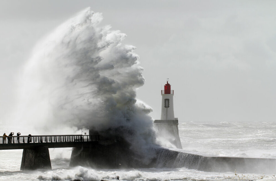 A storm and strong waves hitting a lighthouse