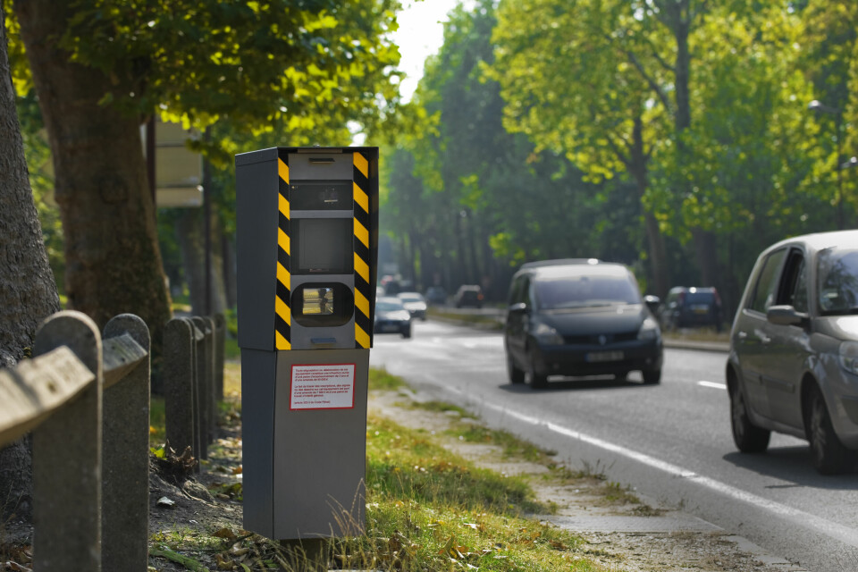 A photo of a tall automatic speed camera on the side of a road in France
