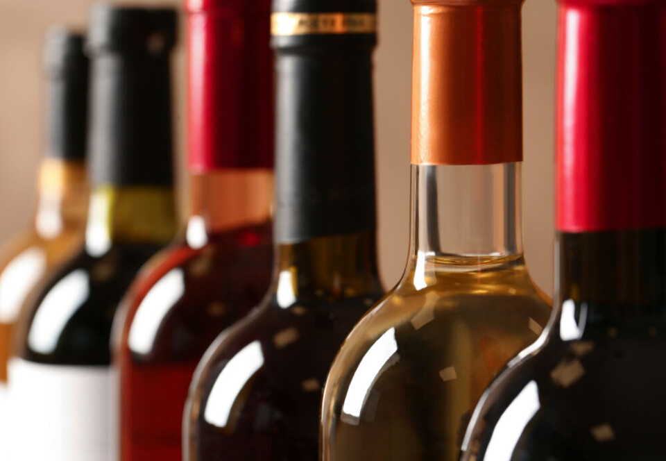 New Africa / Shutterstock A view of wine bottles lined up with their labels not visible