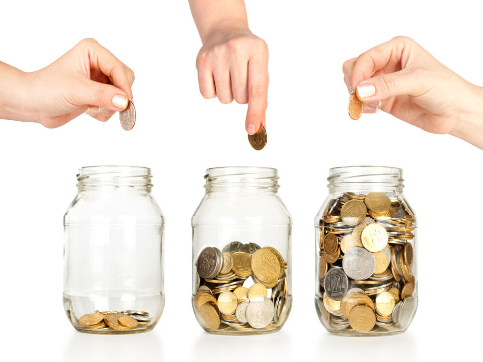 Three glass jars with different amounts of coins and people putting money in each