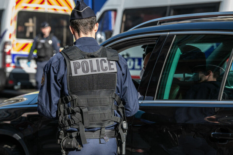 A French policeman next to a car