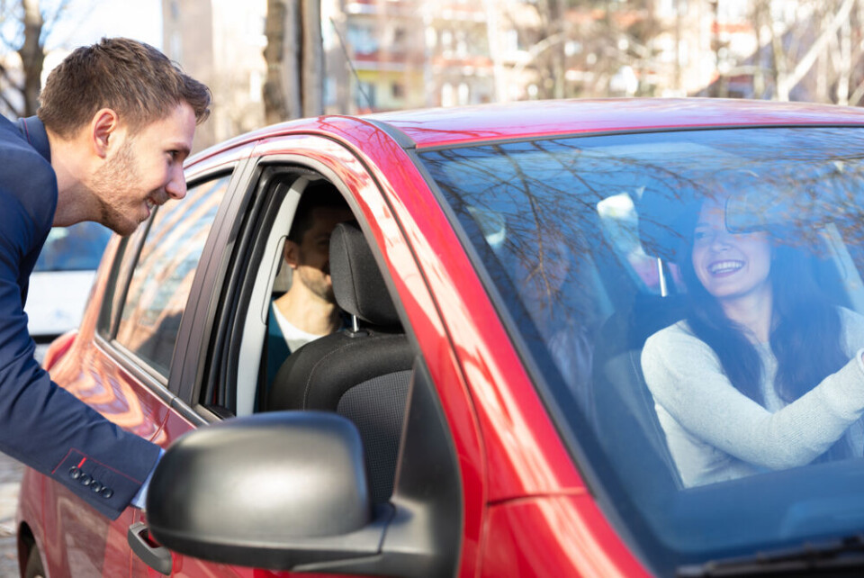 Andrey_Popov / Shutterstock A man getting into a car with colleagues to car-share