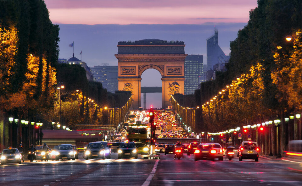 Cars driving on the Champs-Elysees in Paris at night