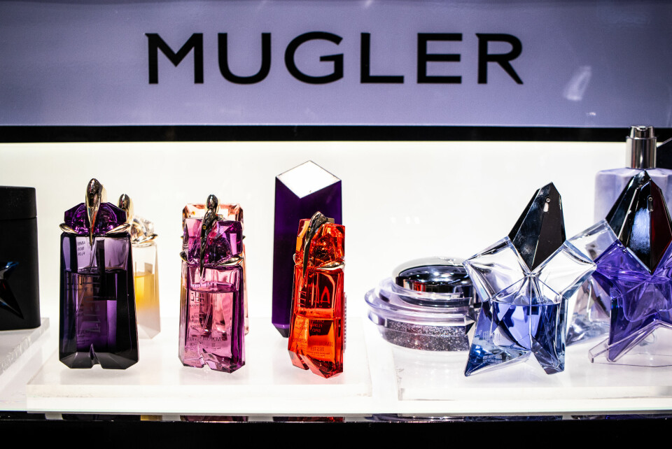 A selection of Thierry Mugler perfumes on a branded shelf