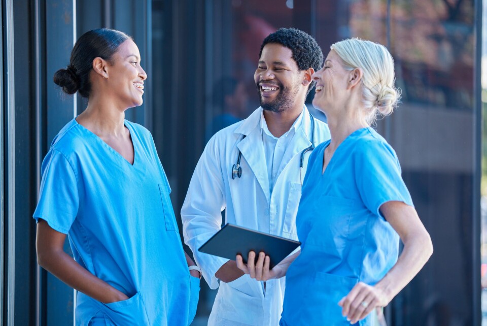 A photo of diverse healthcare workers laughing and chatting