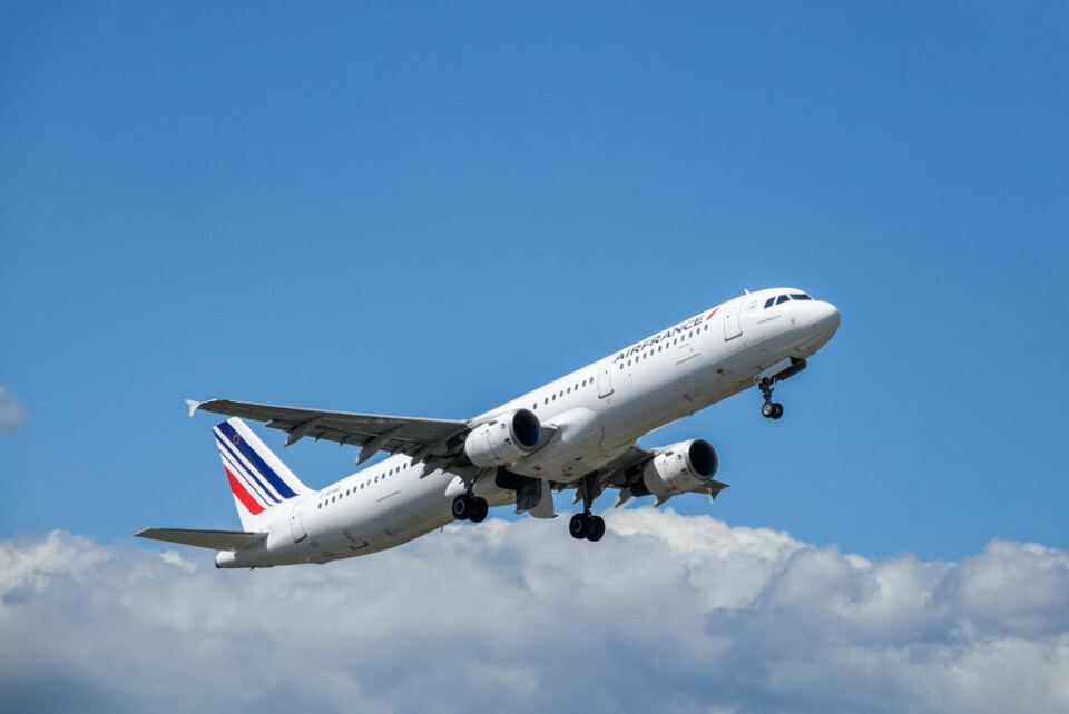 An Air France plane flying above clouds