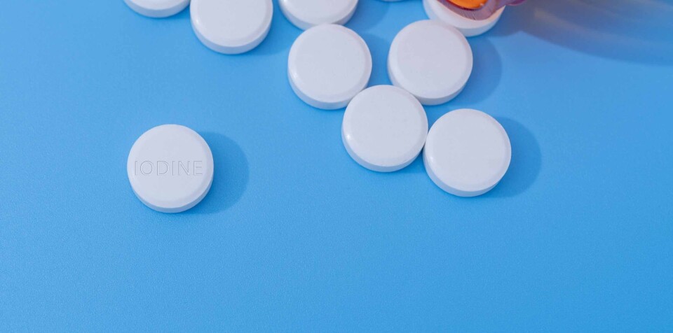 luchschenF / Shutterstock An image of white pills spilling out of a bottle