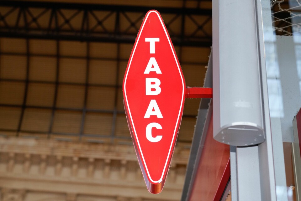 A photo of a TABAC red sign outside a tabac shop in Bordeaux, France