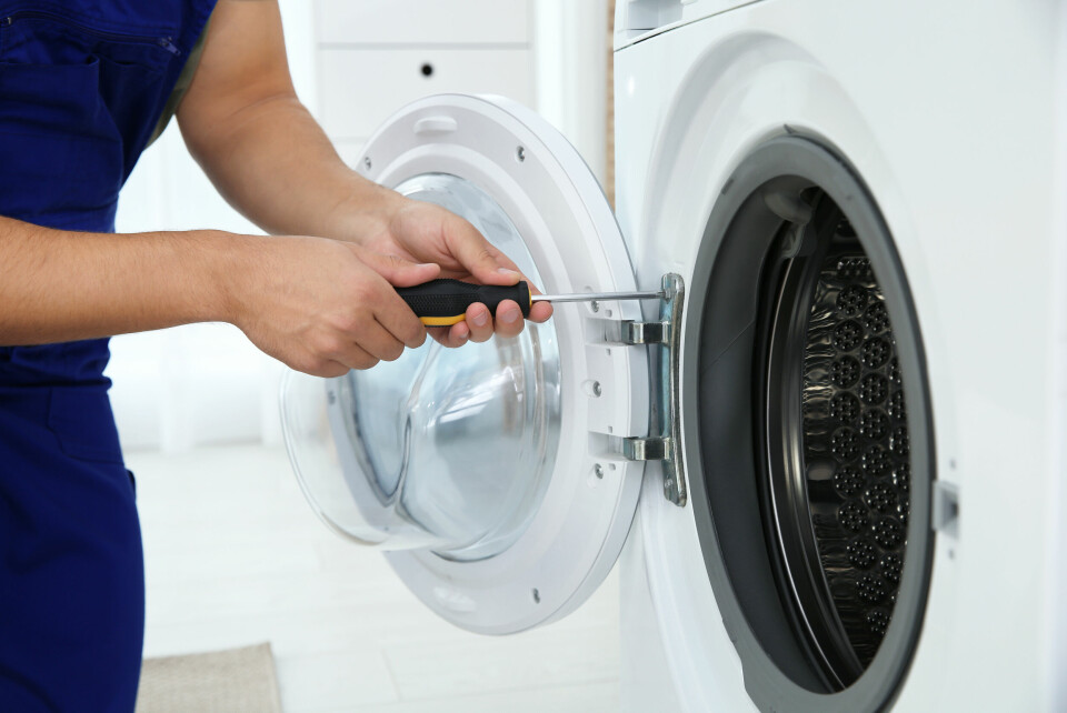 A man repairing a washing machine