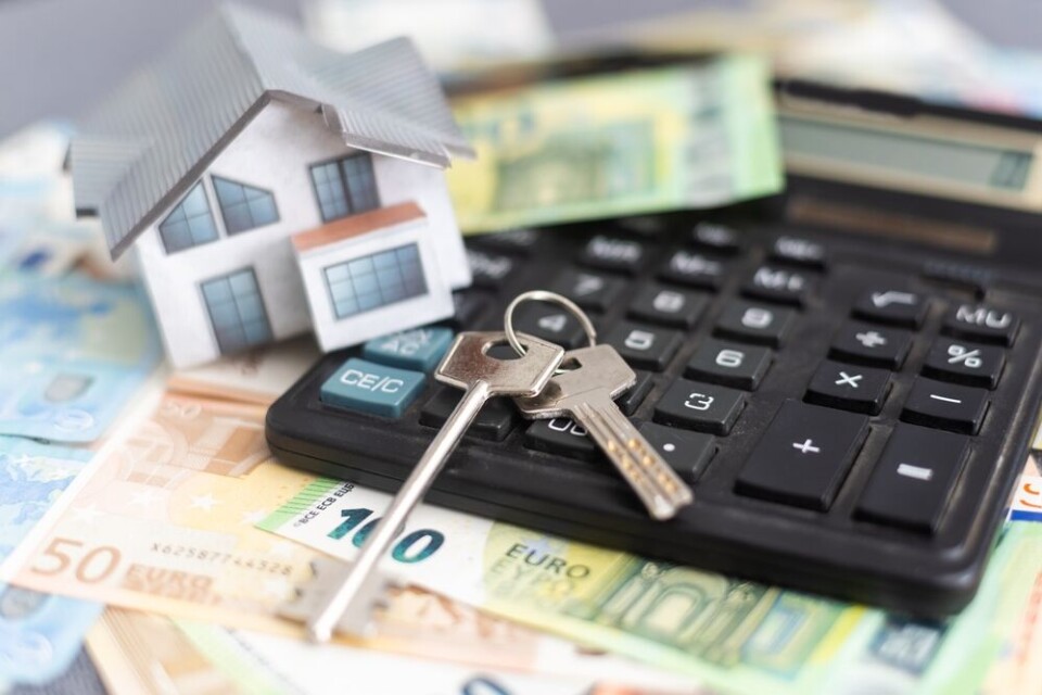 A view of a model house, some keys, and a calculator