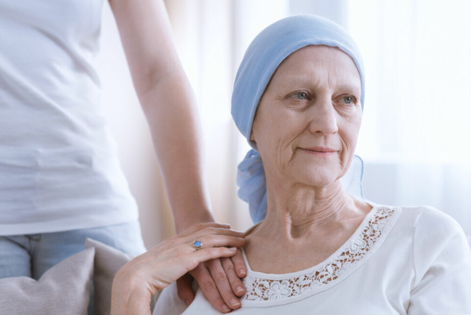 An older woman wearing a head cap after losing her hair due to cancer