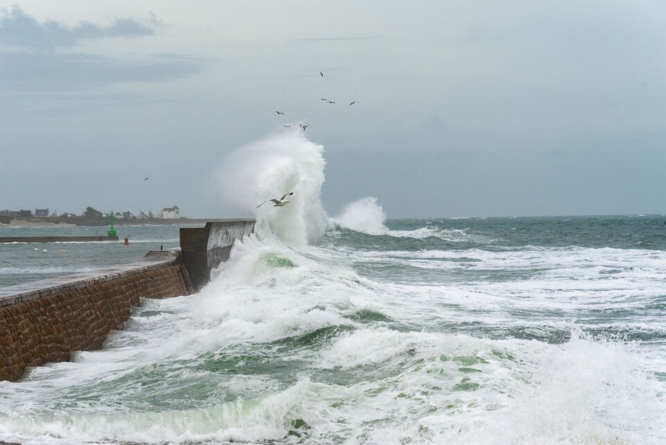 Laurent 3D | Shutterstock Powerful waves hit a jetty in Brittany