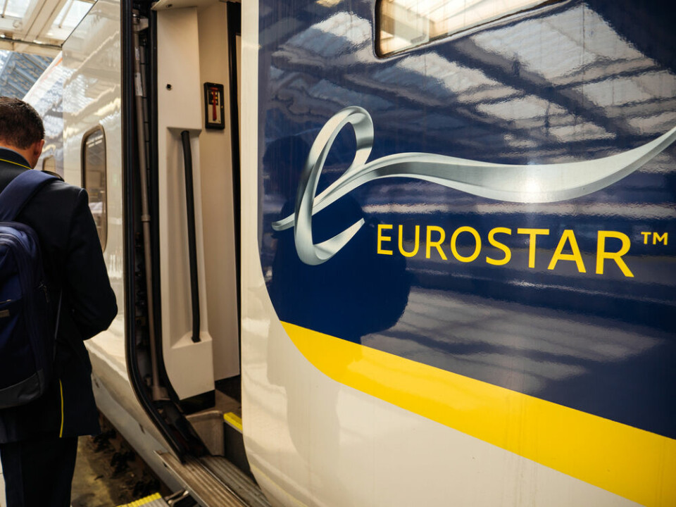 A view of a Eurostar train with a door open on a train platform