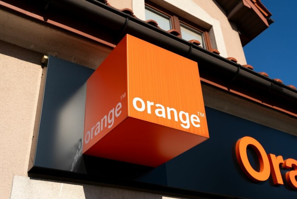 A view of an Orange shop with the logo out front