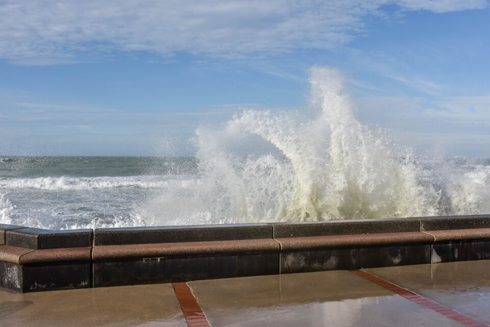 ID-VIDEO / Shutterstock A wave crashing over a sea wall in France