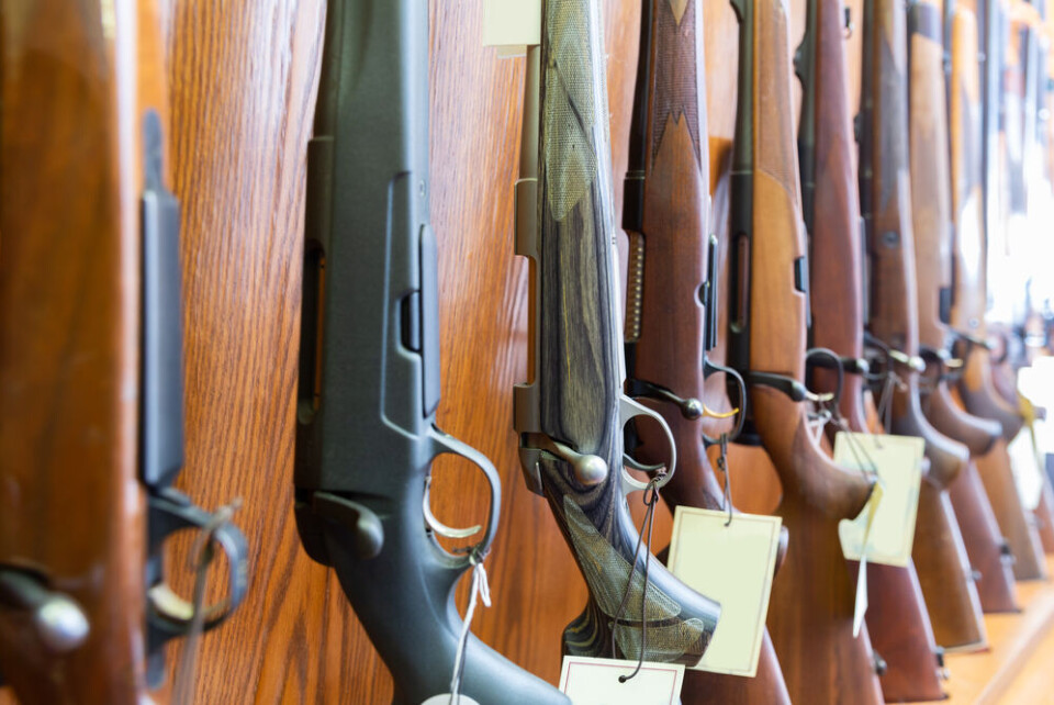BearFotos / Shutterstock A row of guns on a wall with labels