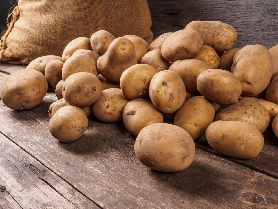 Dmitriy Gutkovskiy / Shutterstock Pile of raw potatoes lying on wooden boards