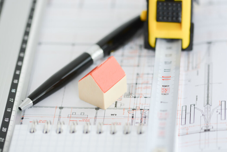 Eviart / Shutterstock A view of a building plan, tape measure, and a pen