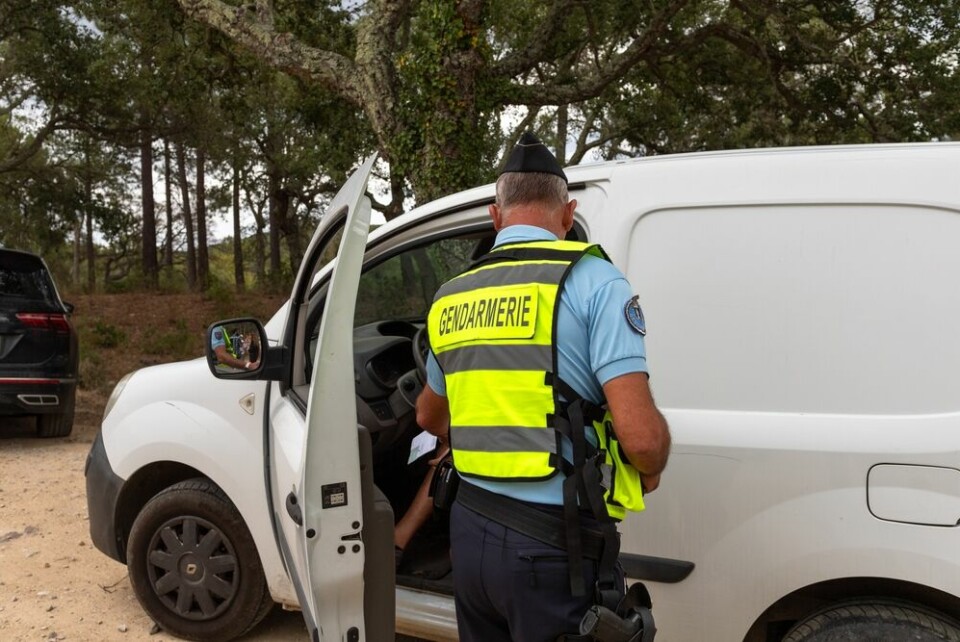 A gendarme talking to the driver of a van in France