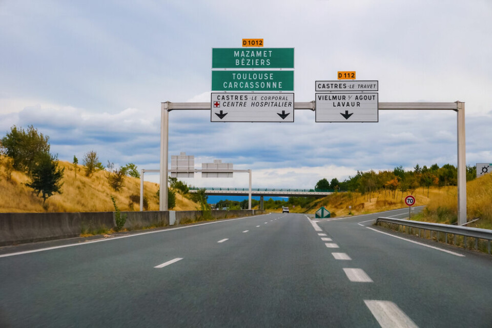 A view of a motorway with signs to Castres, Toulouse, and Carcassonne