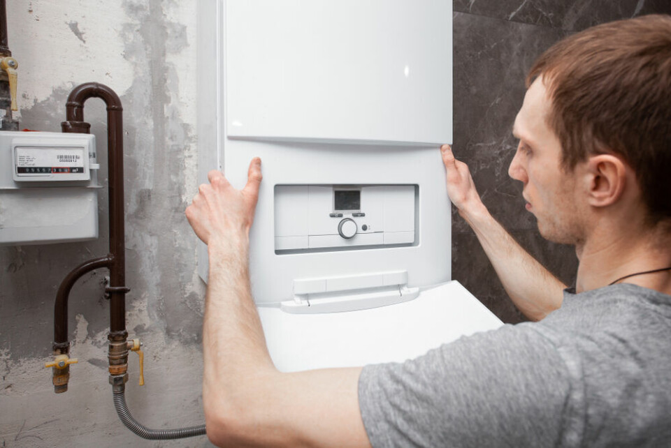 A person installing a new boiler