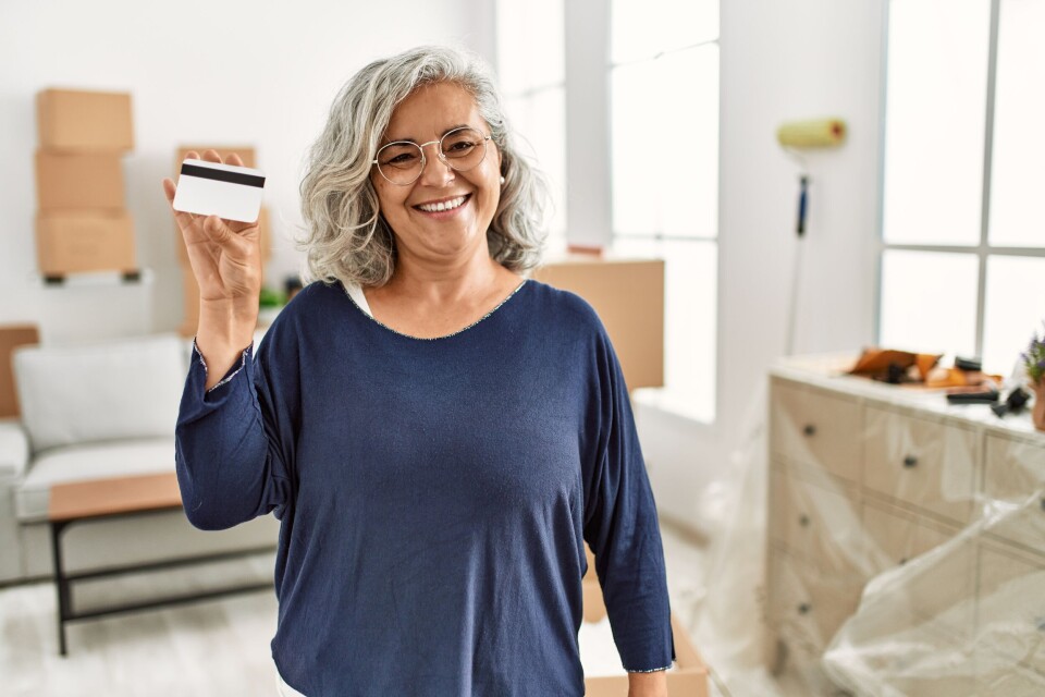 Krakenimages.com / Shutterstock An elderly person holding a plastic card