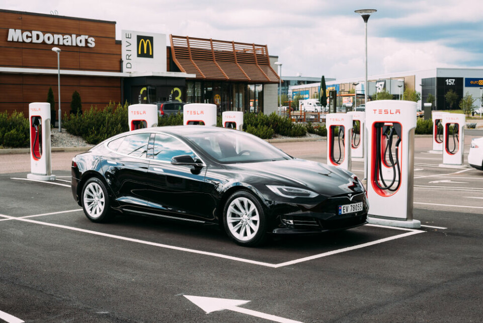 A view of a Tesla electric car recharging in a McDonald’s car park