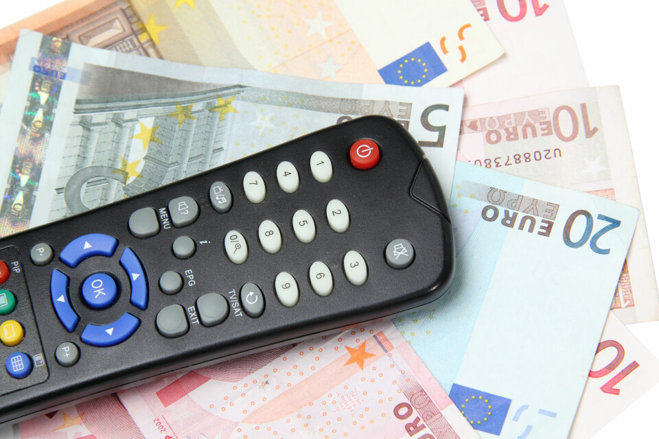 A TV remote control on some euro banknotes