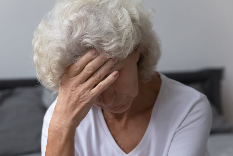 fizkes / Shutterstock An older woman with her head in her hand