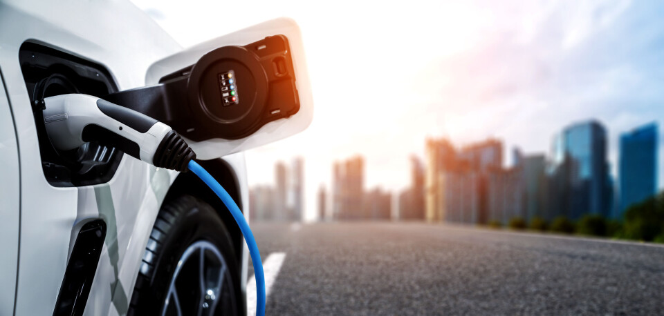Blue Planet Studio / Shutterstock A photo of an electric car charging with a city in the background