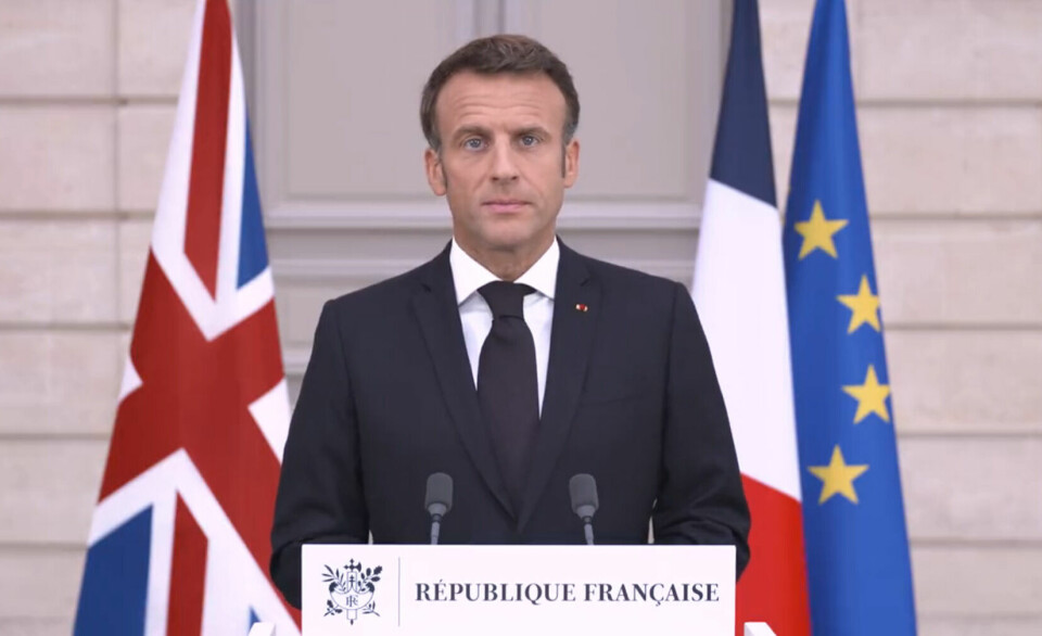 An image of President Macron against a background of the French and EU flags next to a Union Jack