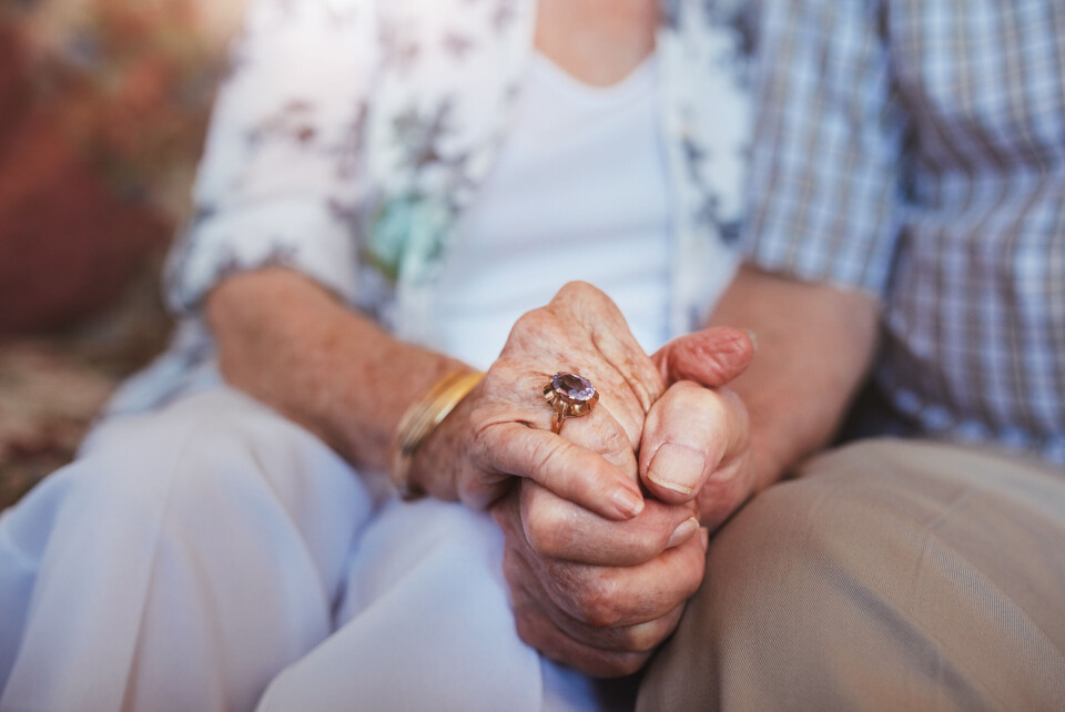 Older couple holding hands