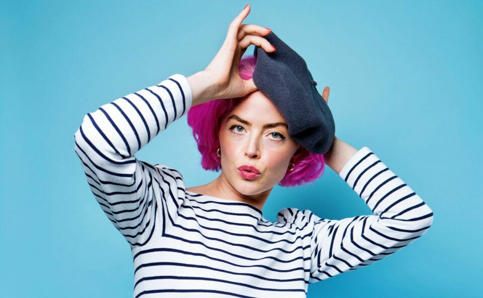 Bilingual comedian wearing French beret and stripy top