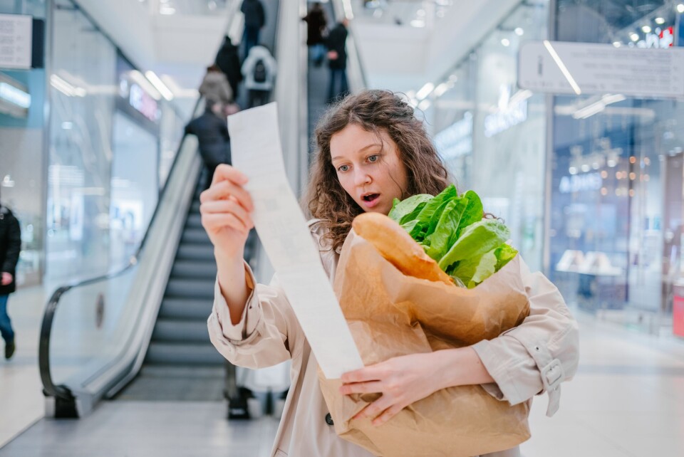 PERO studio / Shutterstock A photo of a woman looking shocked at her food bill