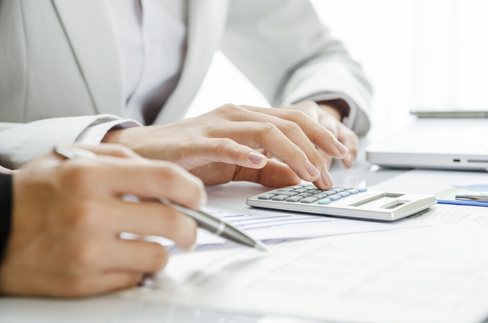 Hands on paperwork at table