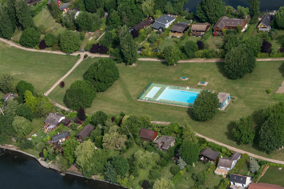 Aerial photo showing a large swimming pool in a field in France