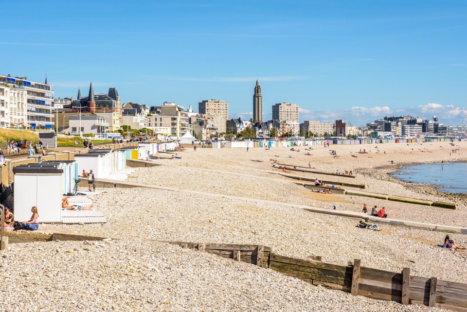 View of a beach in Le Havre, with Saint-Joseph church spire visible in the background