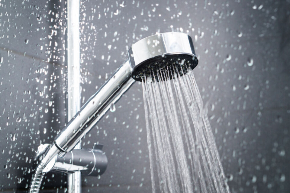 Tero Vesalainen / Shutterstock A view of a chrome shower head running water