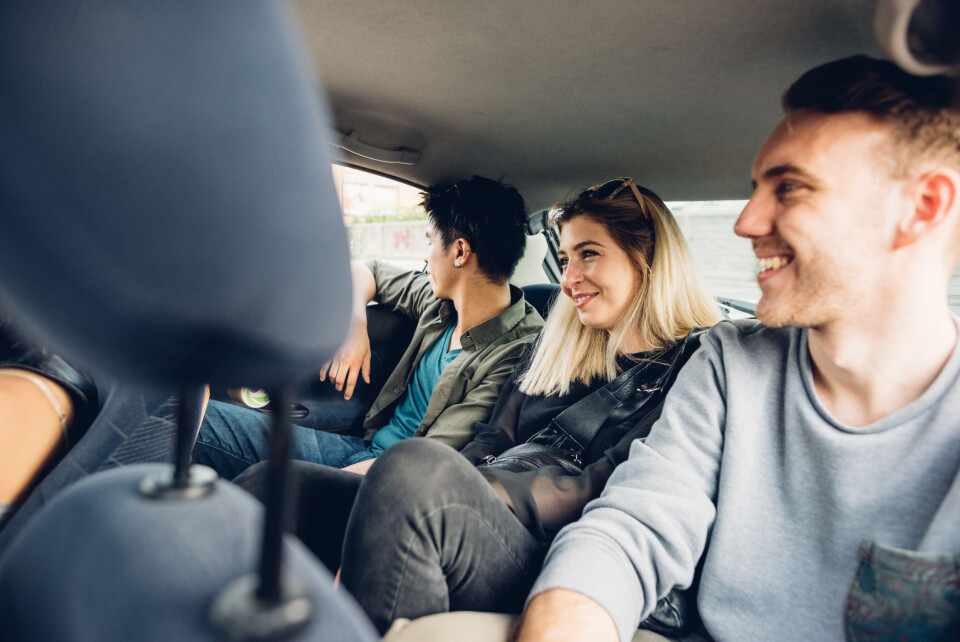 A group of young people share a car