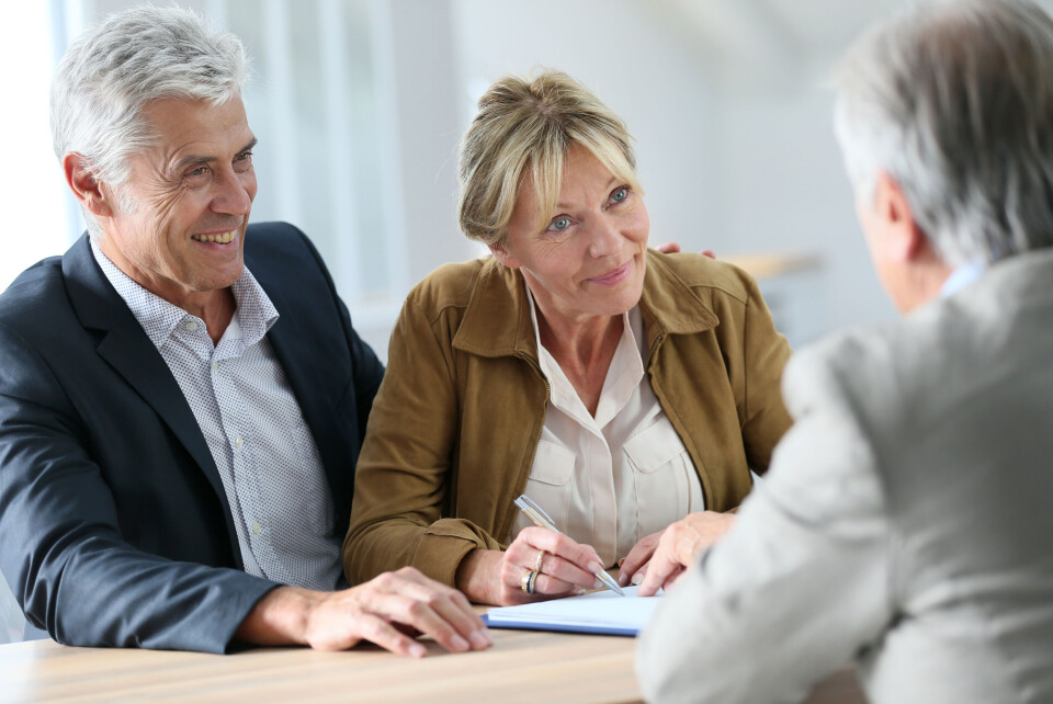 Older couple sign will document with professional