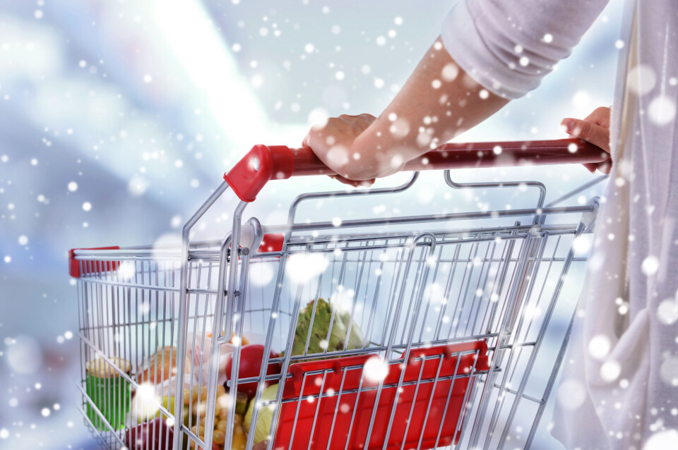 Africa Studio / Shutterstock A photo of a woman shopping in a supermarket with a Christmas snow concept