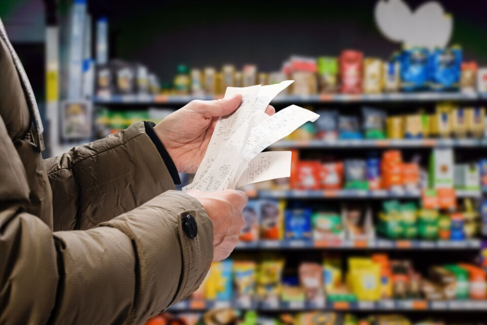 A man looking at receipts in a supermarket